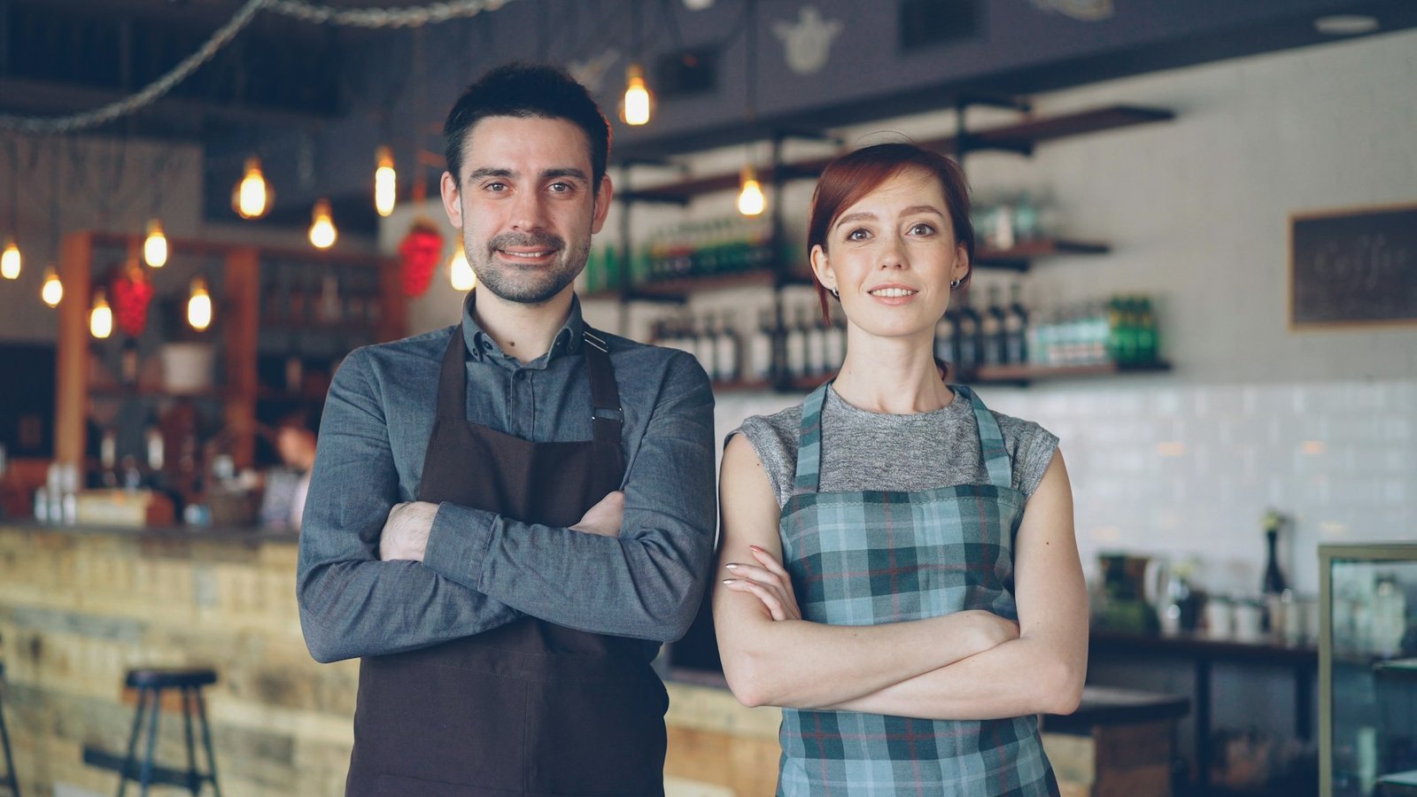 Two independent cafe owners posing in their London coffee shop