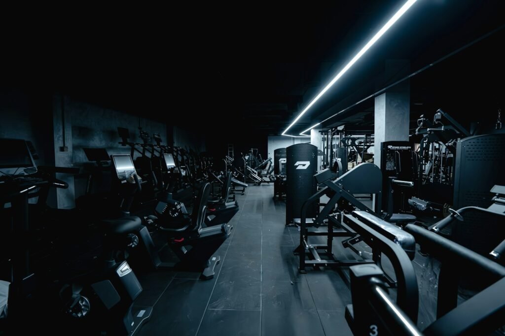 Dark gym interior with weight machines